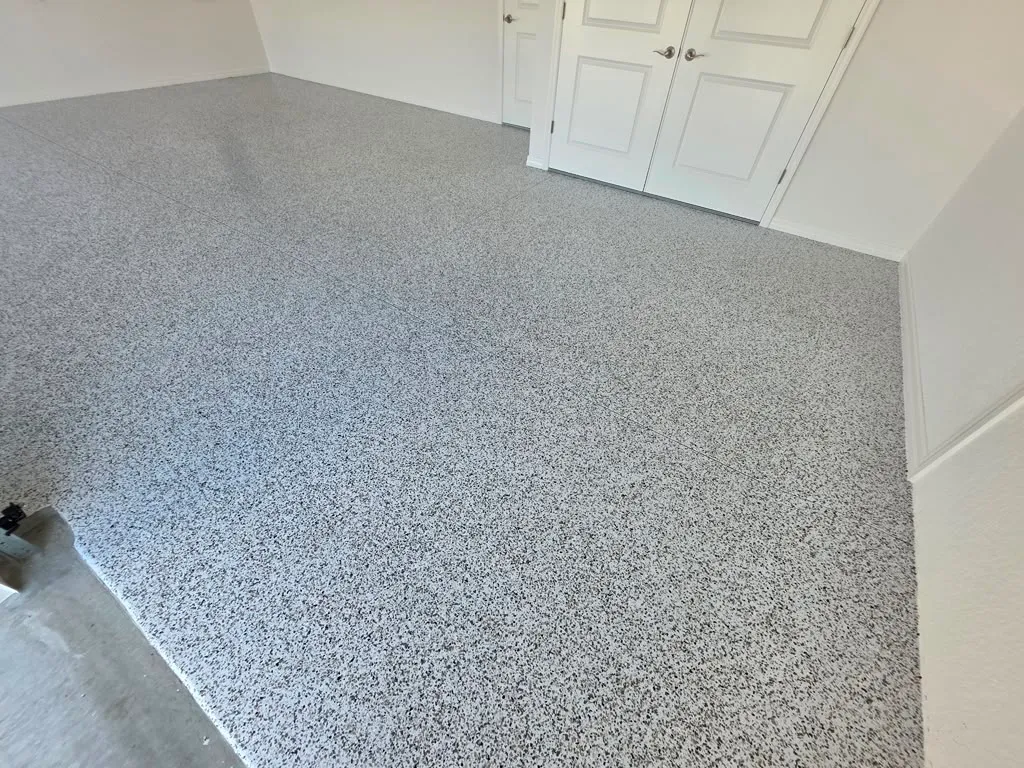 Light gray flake epoxy garage floor in a home